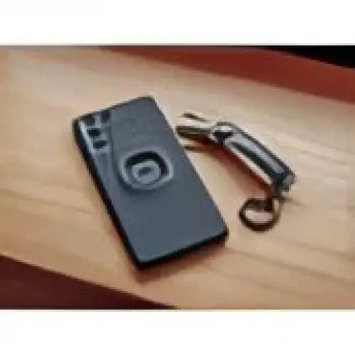 Black smarttelefon med sirkulært pop socket for Quad Lock Mobilholder