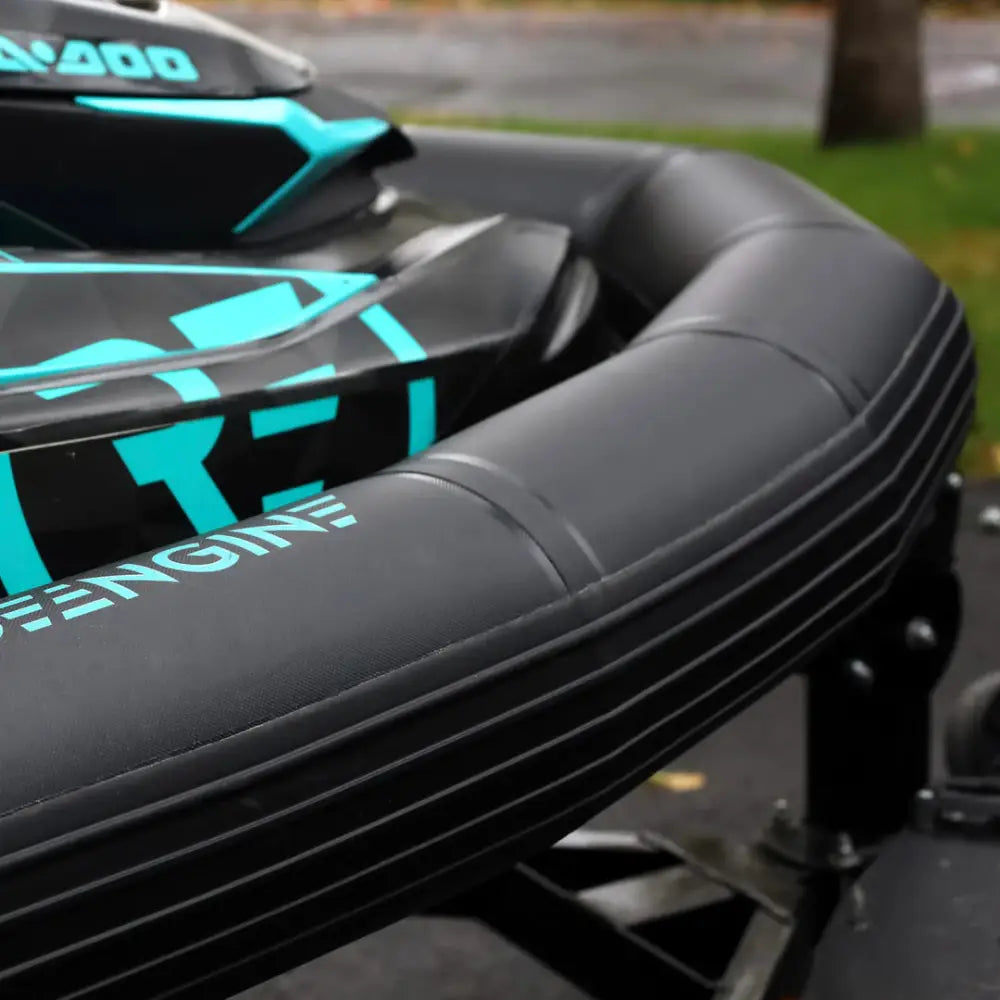 Black inflatable ride engine base pwc collar plus boat with teal accents and 400 branding visible on side