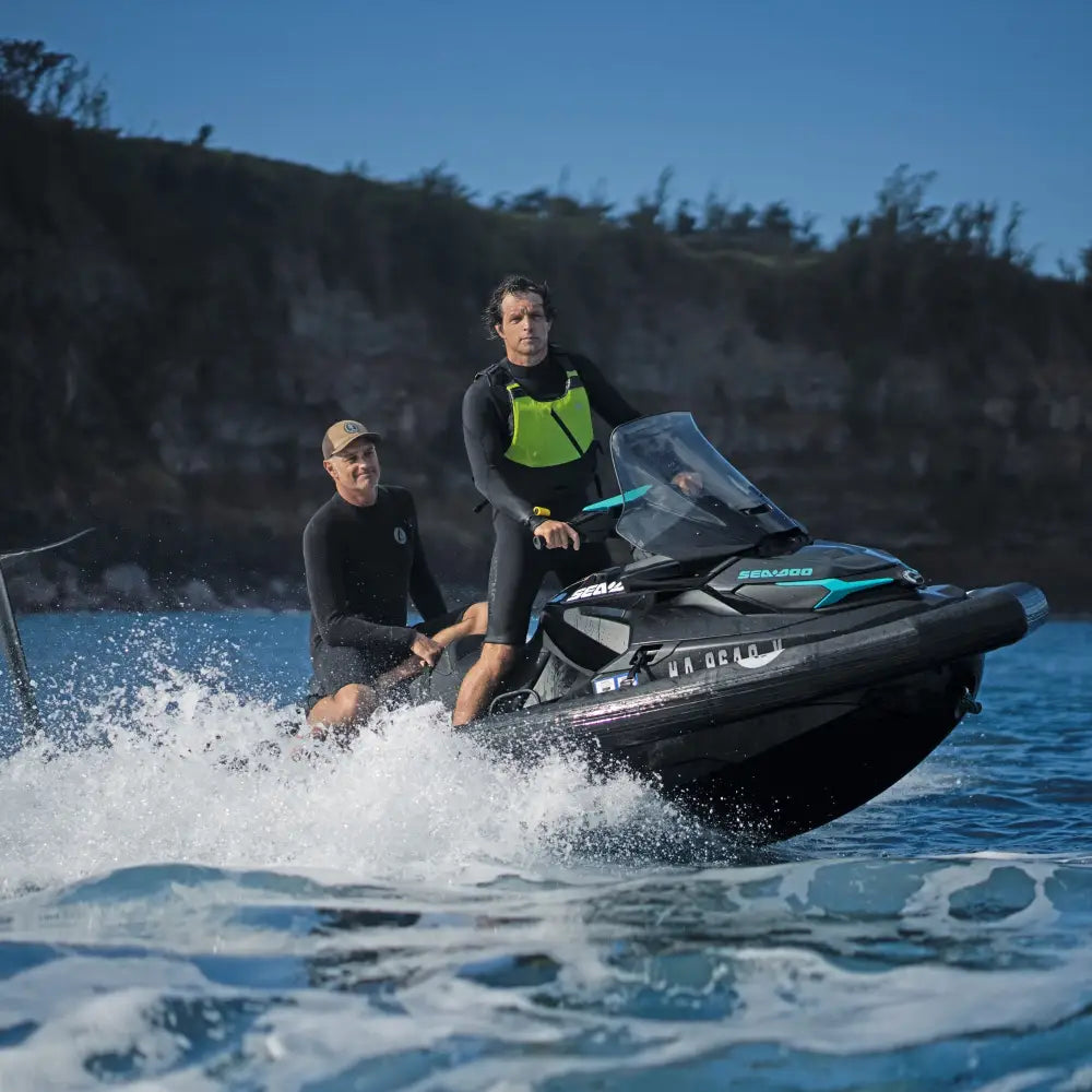 Black and teal sea-doo gtx personal watercraft with pro collar plus speeding across the water